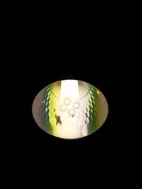 Close-up of illuminated lamp against black background