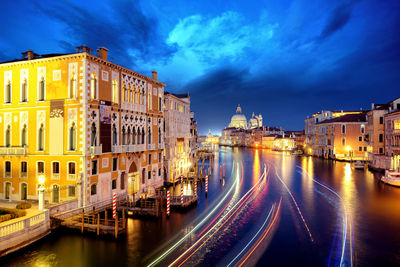 View of illuminated buildings against cloudy sky