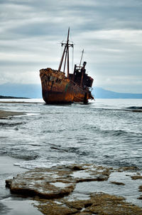 Sailboat on sea against sky