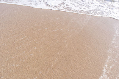 High angle view of waves rushing towards shore