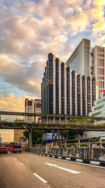 Buildings in city against sky during sunset