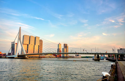 View of bridge over river against cloudy sky