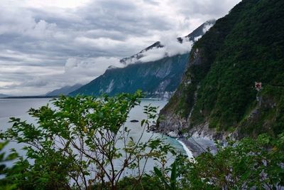 Scenic view of mountains against cloudy sky