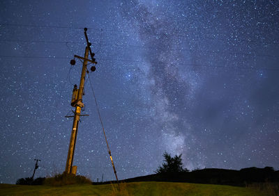 Low angle view of windmill against sky at night