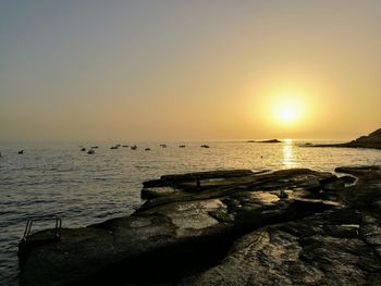 Scenic view of sea against clear sky during sunset