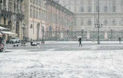 Man walking in city during winter