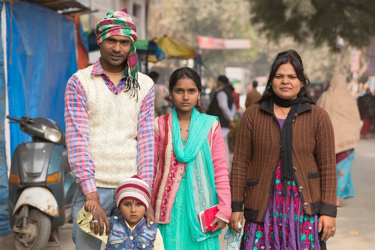 young adult, looking at camera, portrait, young women, focus on foreground, front view, lifestyles, smiling, happiness, real people, leisure activity, casual clothing, young men, day, outdoors, standing, togetherness, sari, warm clothing, adult, people, adults only