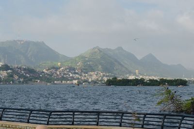 Scenic view of sea and mountains against sky