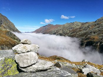 Scenic view of rocky mountains against blue sky