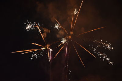 Low angle view of firework display at night