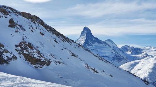 Scenic view of snowcapped mountains against sky