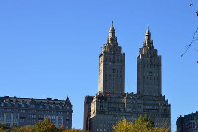 Low angle view of buildings against clear blue sky