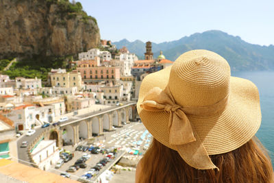Rear view of woman wearing hat at amalfi coast