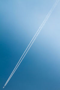 Low angle view of vapor trail