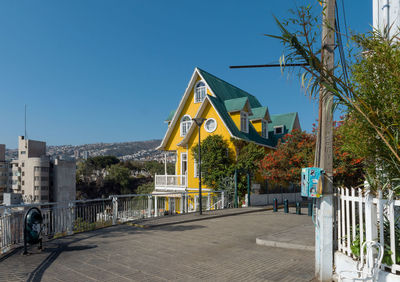 Built structure by building against clear blue sky