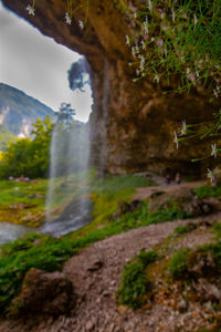 Scenic view of waterfall against sky