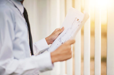 Midsection of man working on paper