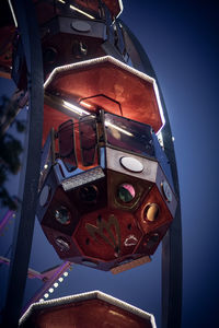 Low angle view of telephone booth against clear blue sky