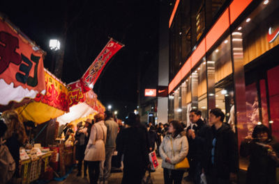 People walking on street at night