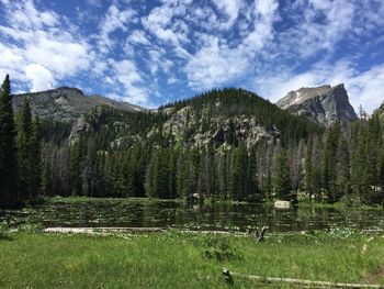 Scenic view of lake and mountains against sky