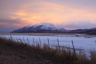 Beautiful snowy mountain and farmland at dusk, utah, usa