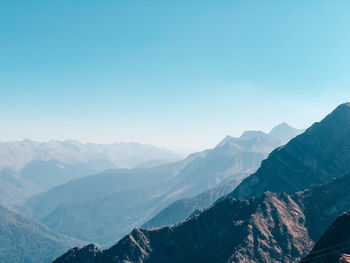 Scenic view of mountains against clear blue sky