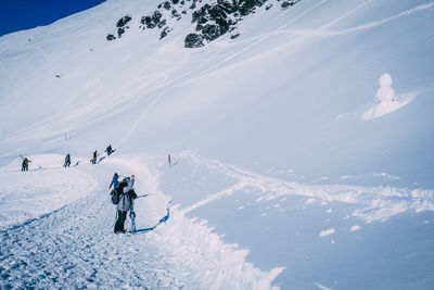 High angle view of people skiing on snowcapped mountain