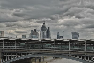 View of modern buildings against cloudy sky