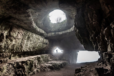 View of cave through tunnel