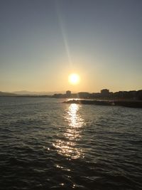 Scenic view of sea against clear sky during sunset