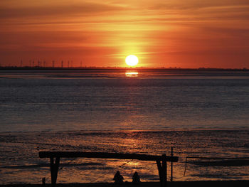 Scenic view of sea against orange sky