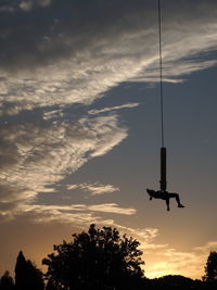 Low angle view of silhouette trees against sky during sunset