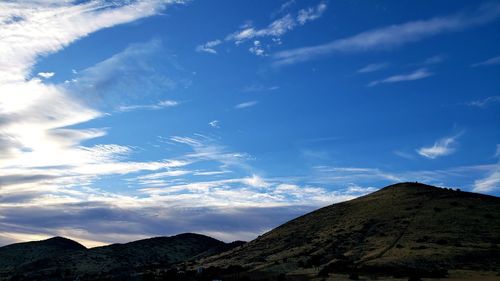 Low angle view of mountain against blue sky