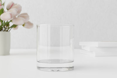 Close-up of white flower in glass on table