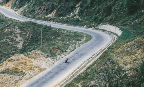 High angle view of person riding motorcycle on road