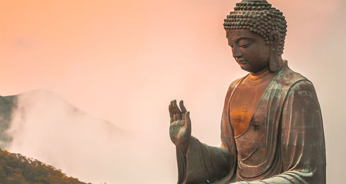 Statue of buddha against sky