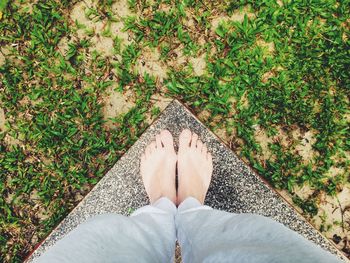 Low section of woman standing on retaining wall