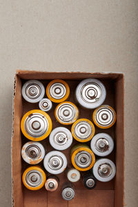 Discharged batteries in cardboard box. collecting used batteries to recycle