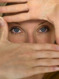 Portrait of woman forming frame with hands