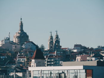 View of buildings in city against clear sky