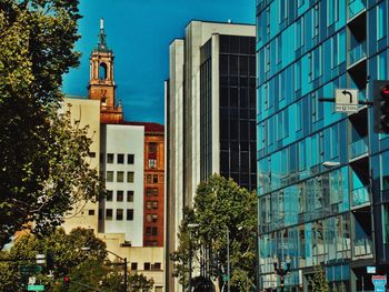 Low angle view of buildings against blue sky