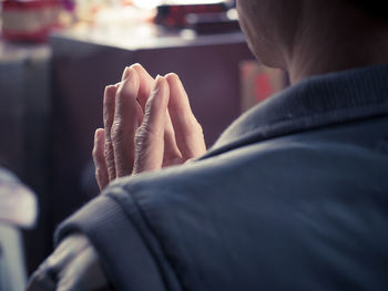 Rear view of man holding hands