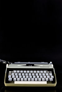 Close-up of laptop on table against black background