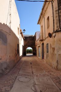 Empty alley amidst buildings in town