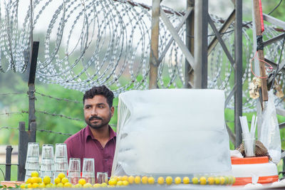 Portrait of young man selling lemon water in lahore