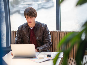 Businessman works with laptop and paper organiser in co-working center. workplace for freelancers