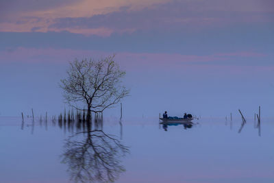 Scenic view of lake against sky during sunset