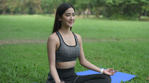 Portrait of woman sitting on field