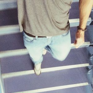 Low section of woman standing on tiled floor