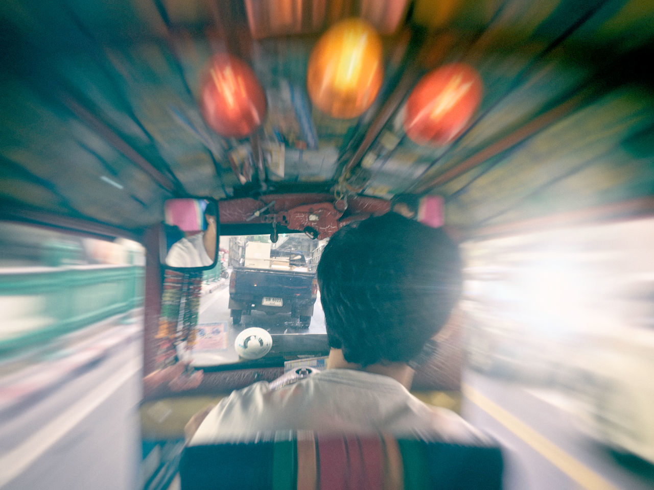 REAR VIEW OF MAN DRIVING CAR